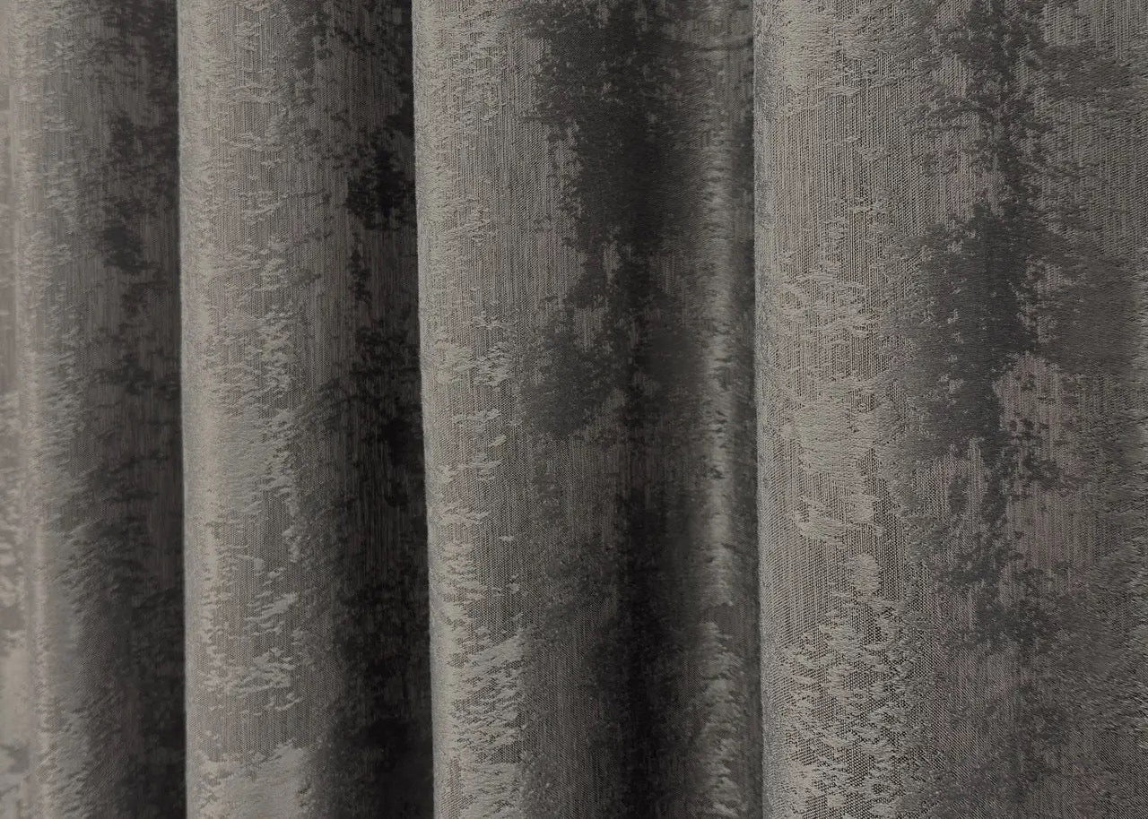 Opulent dark grey curtains with a textured jacquard design, bringing warmth and elegance to your home décor.
