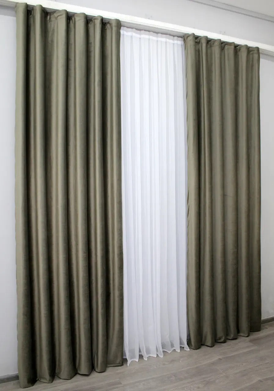 Luxurious moss green velvet curtains with soft texture, ideal for adding a sophisticated touch to your home decor while controlling light.
