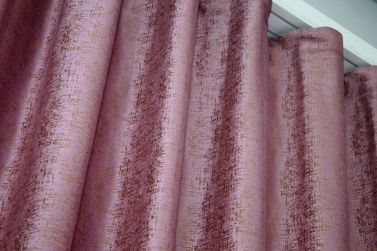 Stylish pink and gold velvet drapes with high-quality fabric, designed for modern interiors with excellent light-blocking properties.
