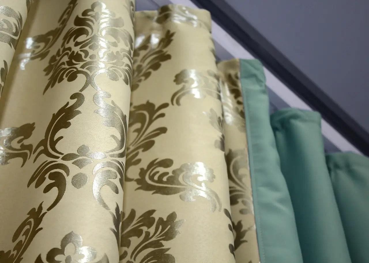 Turquoise and beige blackout curtains that provide both privacy and style with their elegant, modern design.
