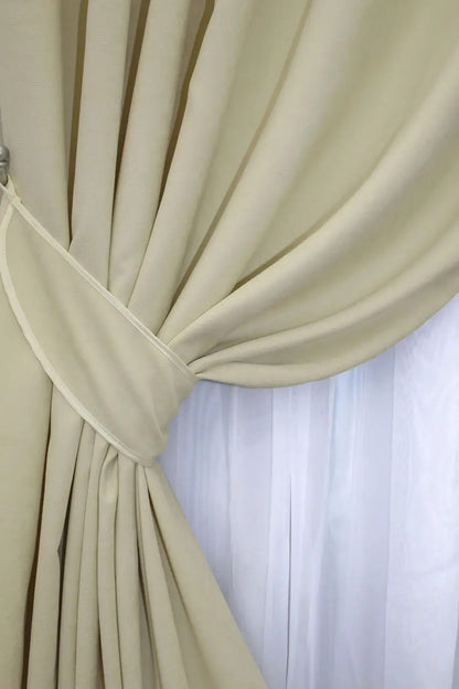 Elegant cream velvet curtains with plush texture, enhancing cosy and stylish home decor.
