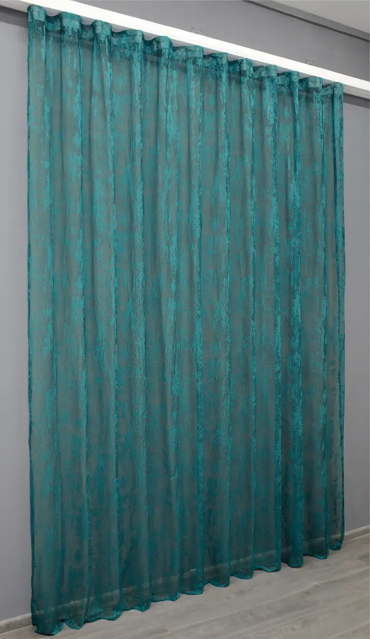 Teal curtain with jacquard texture – lets light in gently