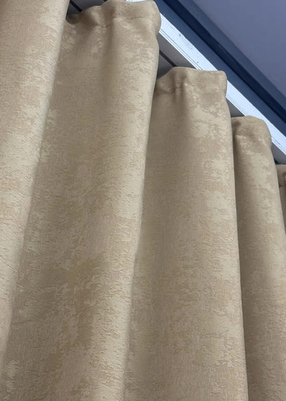 Textured beige jacquard curtains with elegant patterns, adding depth and luxury to any room decor.