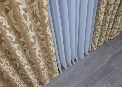 Stylish beige linen drapes with an ornate Venzel design, creating a refined and inviting space.
