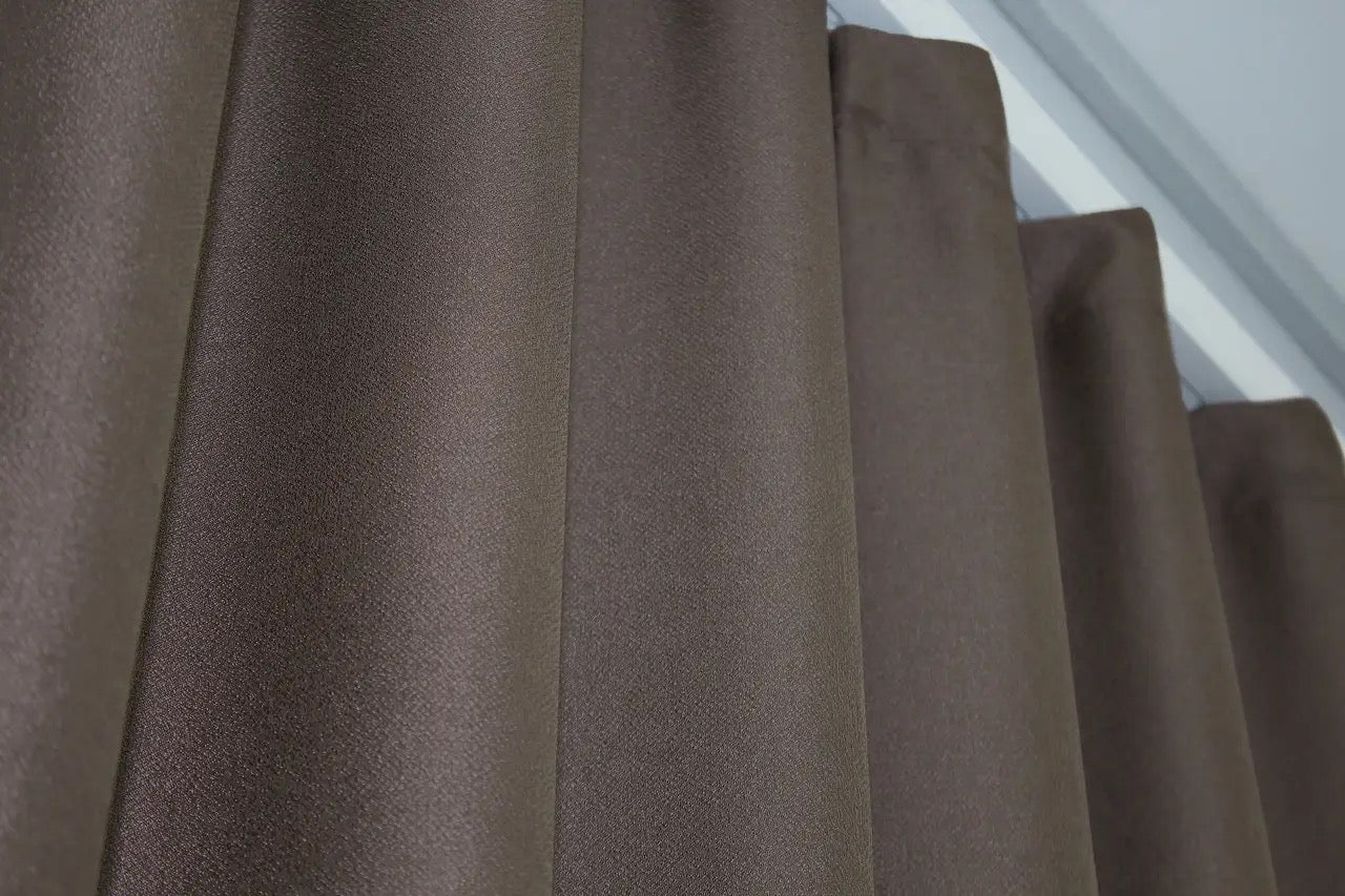 Classic and modern dark brown curtains with subtle gold detailing, ideal for warm and inviting interiors.
