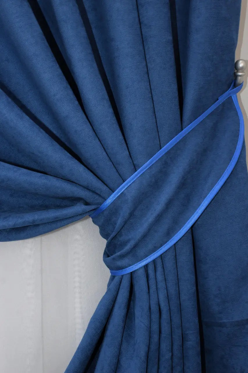 Versatile deep blue curtains, ideal for light filtering and adding depth to interior décor.
