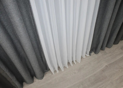 Two-tone grey linen blackout curtains with a smooth drape, ideal for creating a serene and refined atmosphere in any home.
