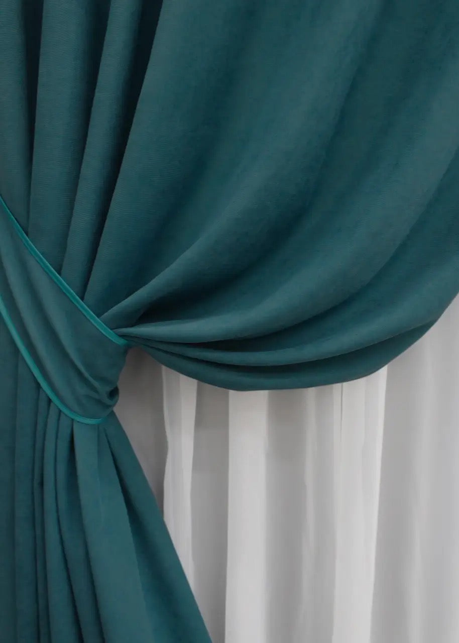 Luxury Petek microvelvet curtains in azure blue, crafted for a soft and flowing drape.
