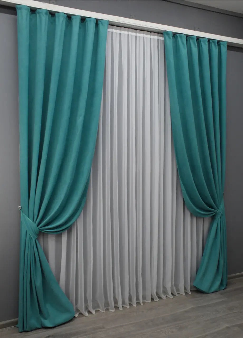 Vibrant turquoise velvet curtains designed for privacy and soft natural light diffusion.
