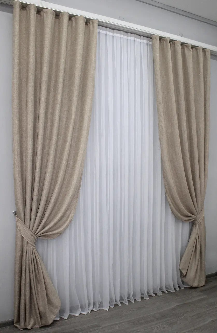 Warm beige linen curtains with a textured fabric, perfect for creating a cozy and inviting home atmosphere.
