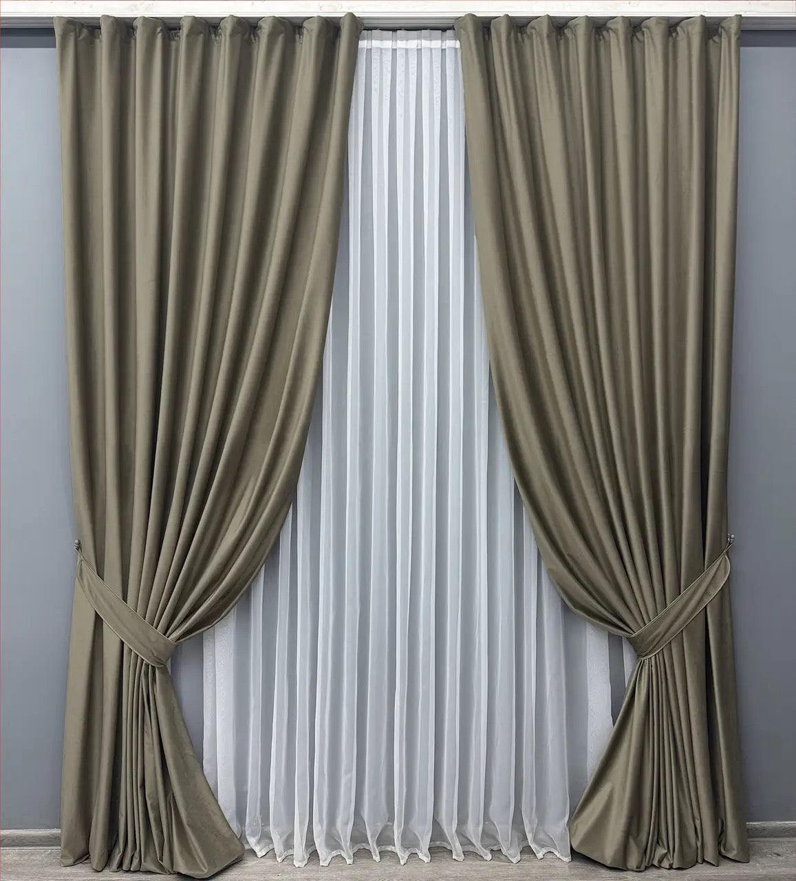 Warm greige velvet drapes with premium-quality fabric, ideal for living rooms and bedrooms, creating a cozy atmosphere.
