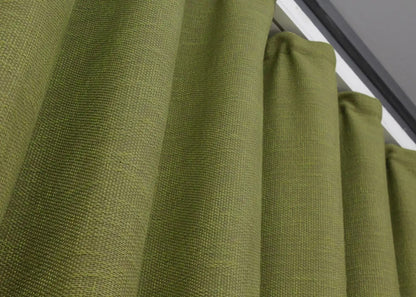 Farmhouse-style light green linen drapes, offering light diffusing properties for a calm and inviting atmosphere.
