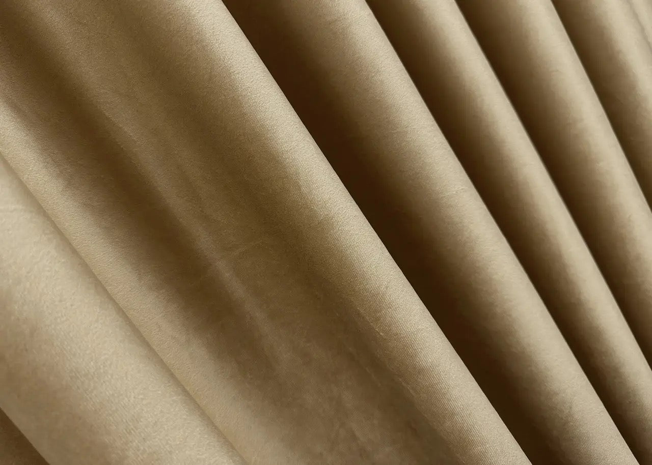 Warm taupe velvet drapes with light-reducing properties, offering a chic and refined touch to any space.
